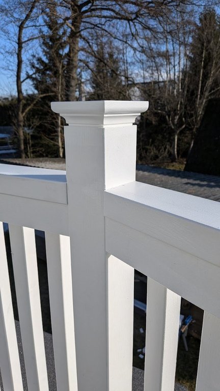 Detail of white balcony railing post and handrail