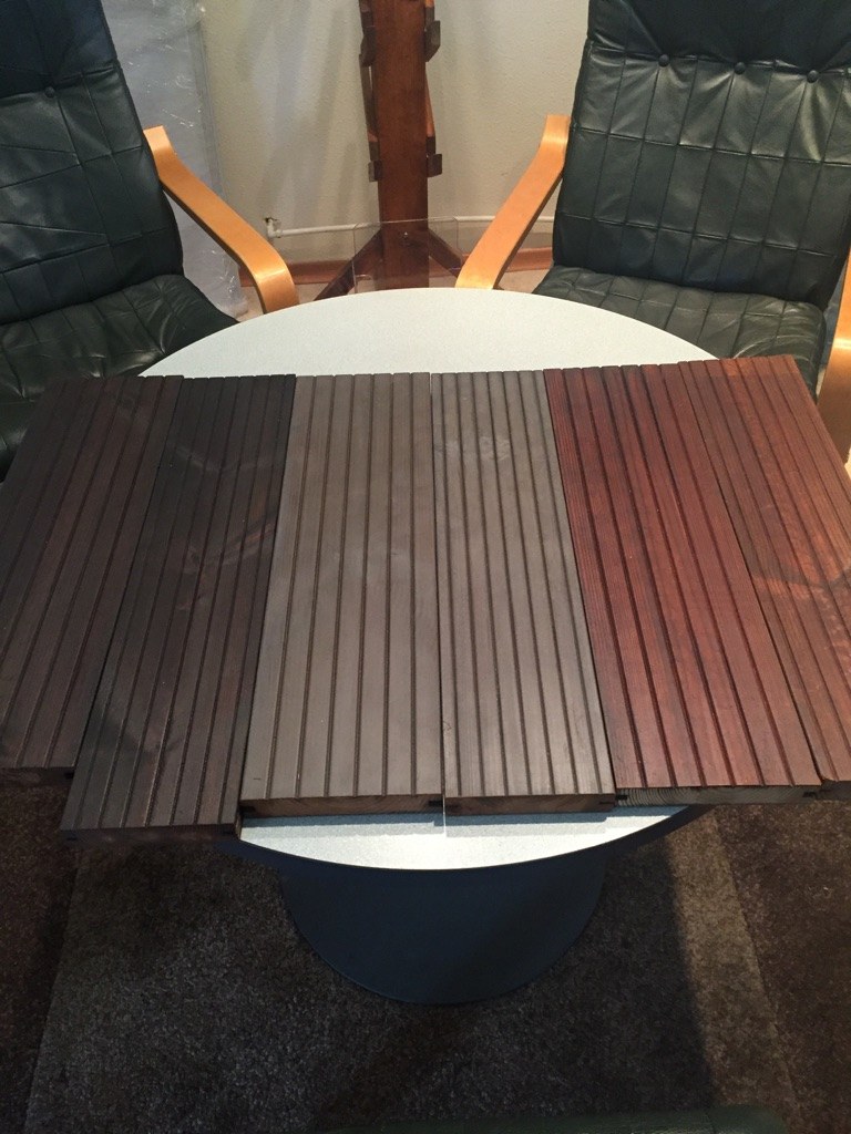 Heat-oiled decking colour samples: dark brown, greys and warm brown