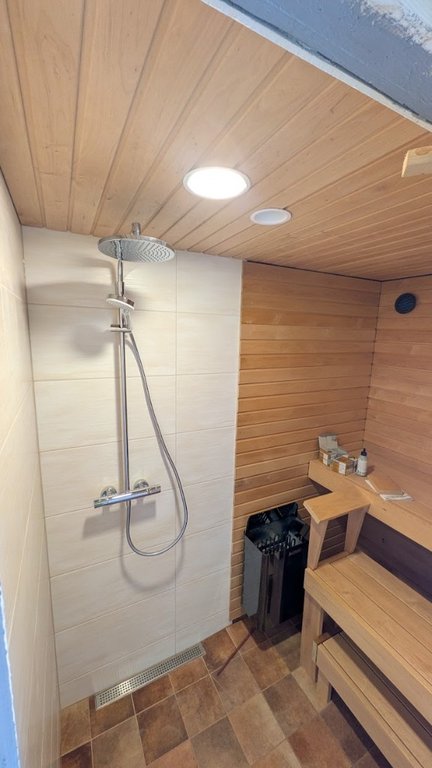 Compact sauna about 1 m² and tiled shower in one room